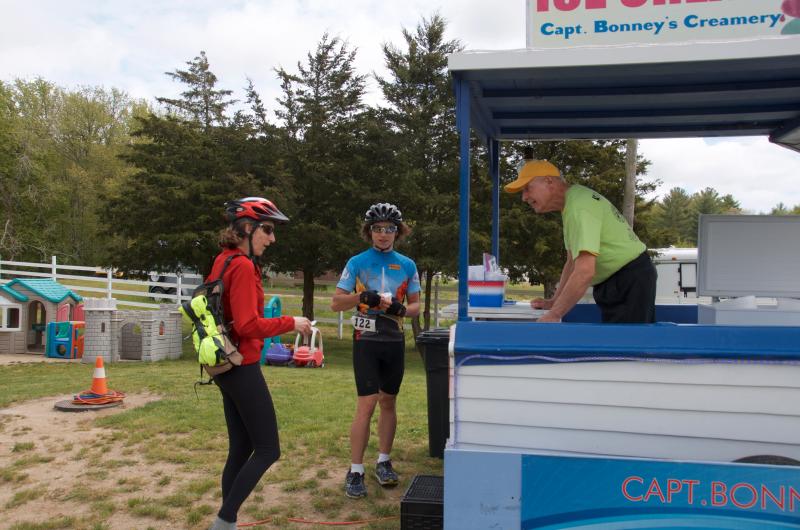 Bill Calusine, a member of the Mattapoisett Lions Club and the Mattapoisett Land Trust, serves ice cream at Captain Bonney's in Rochester. Calusine said he volunteered because "I believe in the causes." BY GEORGIA SPARLING